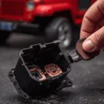 Cleaning dirty copper contacts inside a Power Wheels foot pedal switch to fix ride-on car that clicks but won't move