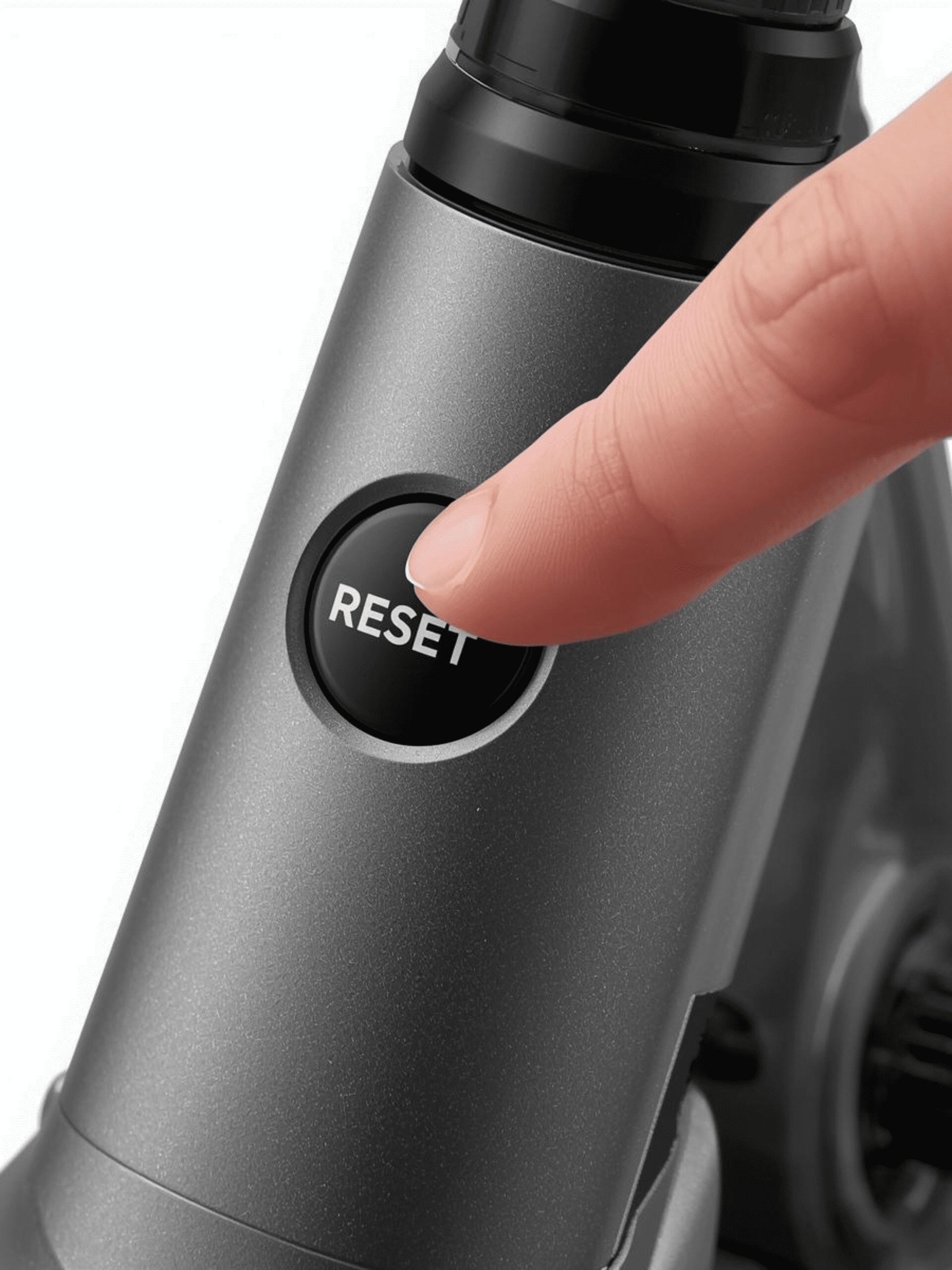 Pressing the circuit breaker reset button on a Razor E300 electric scooter